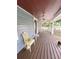 Charming front porch featuring wooden floors, comfortable seating, and a welcoming ambiance at 319 N Scenic Hwy, Frostproof, FL 33843