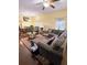 Spacious living room featuring a sectional sofa, ceiling fan, and an open dining area at 319 N Scenic Hwy, Frostproof, FL 33843