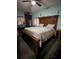 Main bedroom with a large wooden bed frame and a ceiling fan, ample natural light at 319 N Scenic Hwy, Frostproof, FL 33843