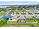 Aerial view of a neighborhood showcasing homes with spacious backyards and screened-in lanais at 341 Alexzander Way, Winter Haven, FL 33881