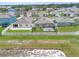 Aerial view of a neighborhood showcasing a spacious backyard with a screened-in lanai and white picket fence at 341 Alexzander Way, Winter Haven, FL 33881
