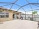 Spacious screened-in back porch with a grill, string lights, and concrete flooring for easy entertaining at 341 Alexzander Way, Winter Haven, FL 33881