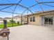 Screened-in back porch with string lights, concrete flooring, and access to the backyard at 341 Alexzander Way, Winter Haven, FL 33881
