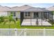 Well-maintained backyard featuring a screened-in lanai, white fence, and lush landscaping at 341 Alexzander Way, Winter Haven, FL 33881
