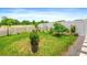 Backyard featuring lush green grass, a white picket fence, and beautiful landscaping at 341 Alexzander Way, Winter Haven, FL 33881