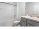 Bright bathroom featuring a shower-tub combo, modern vanity with sink, and neutral-toned tile flooring at 341 Alexzander Way, Winter Haven, FL 33881