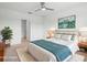 The virtually staged bedroom features an ensuite, overhead lighting, and an accent wall art at 341 Alexzander Way, Winter Haven, FL 33881