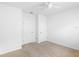 Empty carpeted bedroom featuring a two closets, neutral walls, and ceiling fan at 341 Alexzander Way, Winter Haven, FL 33881