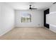 Bright bedroom featuring a modern ceiling fan and an accent wall at 341 Alexzander Way, Winter Haven, FL 33881