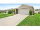 Charming single-story home with a well-manicured lawn and a two-car garage at 341 Alexzander Way, Winter Haven, FL 33881
