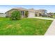 Charming single-story home featuring a neutral paint scheme and a two-car garage with a well manicured lawn and driveway at 341 Alexzander Way, Winter Haven, FL 33881