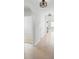 Light and airy hallway with neutral tile flooring, arches and overhead lighting, exuding modern elegance at 341 Alexzander Way, Winter Haven, FL 33881