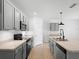 Open kitchen with island, pendant lighting, stainless appliances and gray cabinets at 341 Alexzander Way, Winter Haven, FL 33881