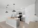 Kitchen features modern island with sink, pendant lights, and stainless appliances at 341 Alexzander Way, Winter Haven, FL 33881