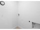 Clean, white laundry room with tile floor and laundry hookups at 341 Alexzander Way, Winter Haven, FL 33881