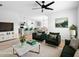 Open-concept living room with stylish furniture and a view to the kitchen at 341 Alexzander Way, Winter Haven, FL 33881
