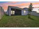 Expansive backyard featuring a screened lanai, lush green grass, and white fencing at 4122 Sagefield Dr, St Cloud, FL 34773