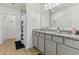 Modern bathroom featuring dual sinks, granite counters, tile floors, and a shower at 4122 Sagefield Dr, St Cloud, FL 34773