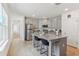 Modern kitchen features stainless steel appliances, granite countertops, a kitchen island with seating, and wood-look floors at 4122 Sagefield Dr, St Cloud, FL 34773