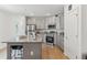 Modern kitchen features stainless steel appliances, granite countertops, a kitchen island with seating, and wood-look floors at 4122 Sagefield Dr, St Cloud, FL 34773