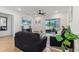 Bright living room features wood floors, a ceiling fan, neutral decor, and sliding glass doors to an outdoor space at 4122 Sagefield Dr, St Cloud, FL 34773