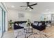 Bright living room features wood floors, a ceiling fan, neutral decor, and access to an adjacent kitchen space at 4122 Sagefield Dr, St Cloud, FL 34773