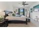 Spacious main bedroom with large bed, dark accents, fan, and natural light at 4122 Sagefield Dr, St Cloud, FL 34773