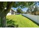 Large backyard showing the vinyl fence line and screen enclosed lanai, providing privacy and comfort for outdoor enjoyment at 4133 Foxhound Dr, Clermont, FL 34711