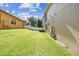Spacious backyard featuring lush green grass and vinyl fencing creating a private outdoor retreat at 4133 Foxhound Dr, Clermont, FL 34711