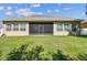Expansive backyard featuring a well-maintained lawn and screened lanai, perfect for outdoor living and entertaining at 4133 Foxhound Dr, Clermont, FL 34711