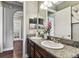 Double vanity bathroom with granite counters, wooden cabinets, and stylish decor at 4133 Foxhound Dr, Clermont, FL 34711