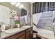 Dual vanity bathroom showcasing granite counters, decorative mirrors, and a relaxing tub at 4133 Foxhound Dr, Clermont, FL 34711