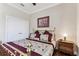 Comfortable bedroom featuring brass bedframe, soft neutral tones, and classic decor with a flower print wall picture at 4133 Foxhound Dr, Clermont, FL 34711