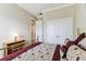 Bright bedroom with a brass bed and a view into the hall showcases closet and doorway access at 4133 Foxhound Dr, Clermont, FL 34711