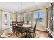 Dining room features an elegant wood table, decorative rug, and lots of natural light from the many windows at 4133 Foxhound Dr, Clermont, FL 34711