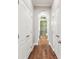 Hallway with hardwood floors leading to the bathroom shower at 4133 Foxhound Dr, Clermont, FL 34711