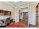 Functional home office with built-in desk and shelves, view to the dining room through open French doors at 4133 Foxhound Dr, Clermont, FL 34711