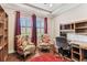 Functional home office featuring large windows, classic desk setup, and cozy armchairs for reading at 4133 Foxhound Dr, Clermont, FL 34711