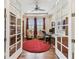 Inviting office space framed by glass doors, complete with built-in shelves and a cozy seating area at 4133 Foxhound Dr, Clermont, FL 34711