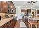 Updated kitchen features stainless appliances, granite counters, tile backsplash, and modern fixtures at 4133 Foxhound Dr, Clermont, FL 34711