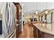 Spacious kitchen with stainless steel appliances, granite countertops, and dark wood cabinets at 4133 Foxhound Dr, Clermont, FL 34711