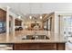 Open concept kitchen showcases granite island with sink and seating, connecting to the living room at 4133 Foxhound Dr, Clermont, FL 34711