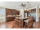 Gourmet kitchen features an oversized island with seating, granite counters, and dark wood cabinetry at 4133 Foxhound Dr, Clermont, FL 34711