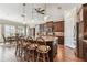 Spacious kitchen with large island, granite countertops, wood floors, and stainless steel appliances at 4133 Foxhound Dr, Clermont, FL 34711