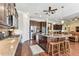 Open kitchen with stainless steel appliances, granite counters, large island, and hardwood floors at 4133 Foxhound Dr, Clermont, FL 34711