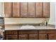 Spacious laundry room with modern cabinets, granite countertop, and white utility sink at 4133 Foxhound Dr, Clermont, FL 34711
