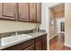 Detailed view of laundry room sink and countertop, with wooden cabinets and hardwood floors at 4133 Foxhound Dr, Clermont, FL 34711