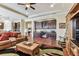 An open-concept space showcases a seating area and office space with built-in dark wood cabinets at 4133 Foxhound Dr, Clermont, FL 34711