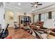 Living room showcasing a coffered ceiling, decorative area rug, and beautiful wood floors at 4133 Foxhound Dr, Clermont, FL 34711