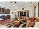 Open-concept living room boasts built-in cabinets, wood flooring, and an elegant leather sofa at 4133 Foxhound Dr, Clermont, FL 34711
